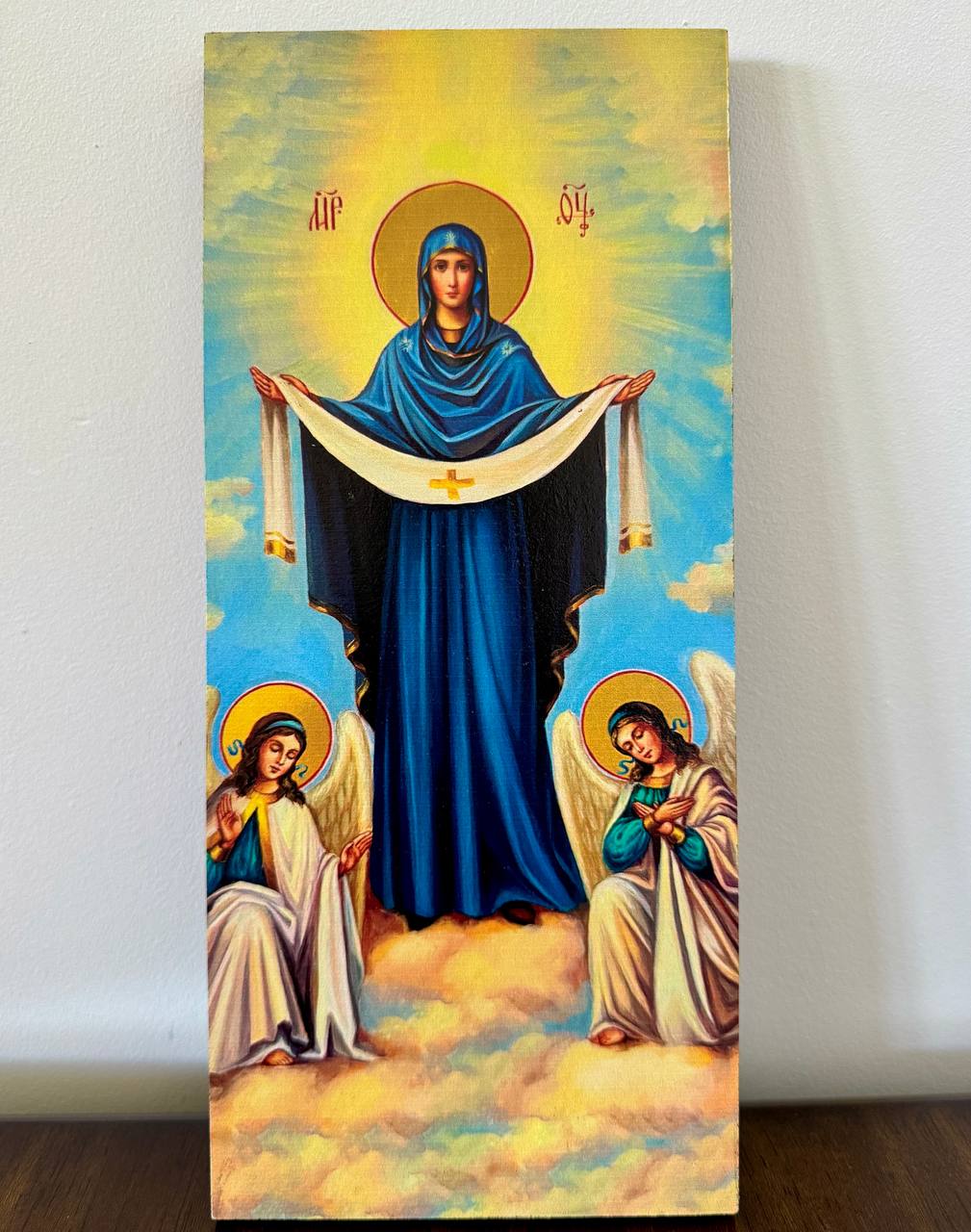 Icon of Mary covering with veil symbolizing divine protection