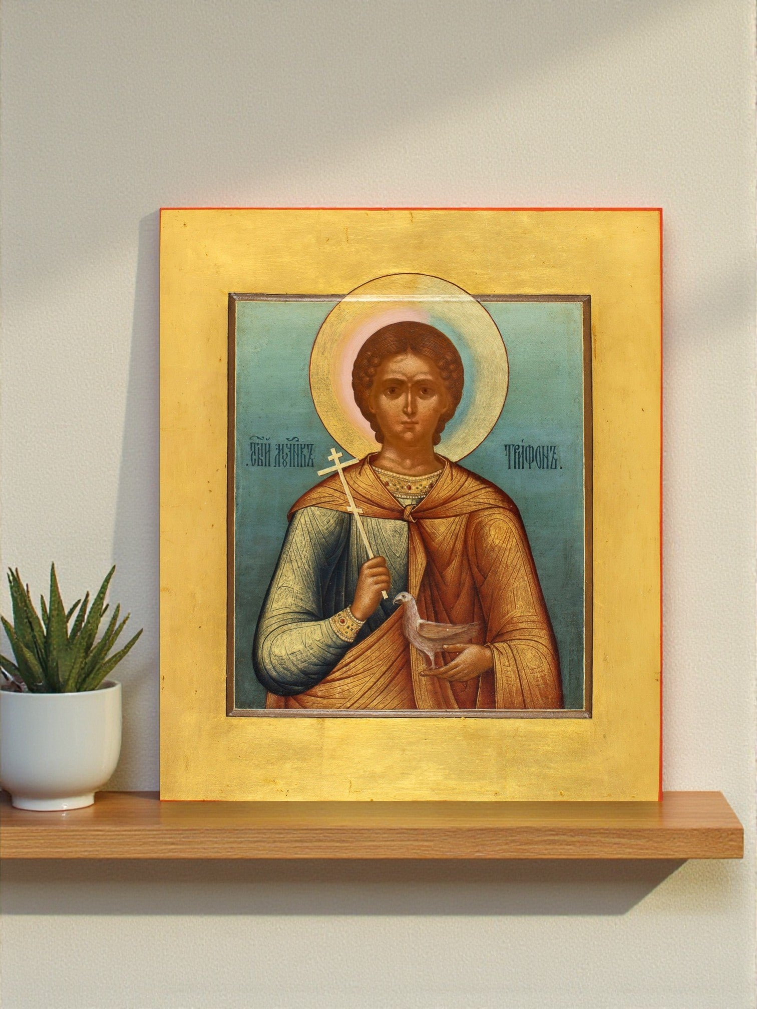 Icon of Saint Tryphon, Russian martyr and protector of crops and animals. A 1900 icon by Mikhail Dikarev symbolizing purity, peace, and divine help.