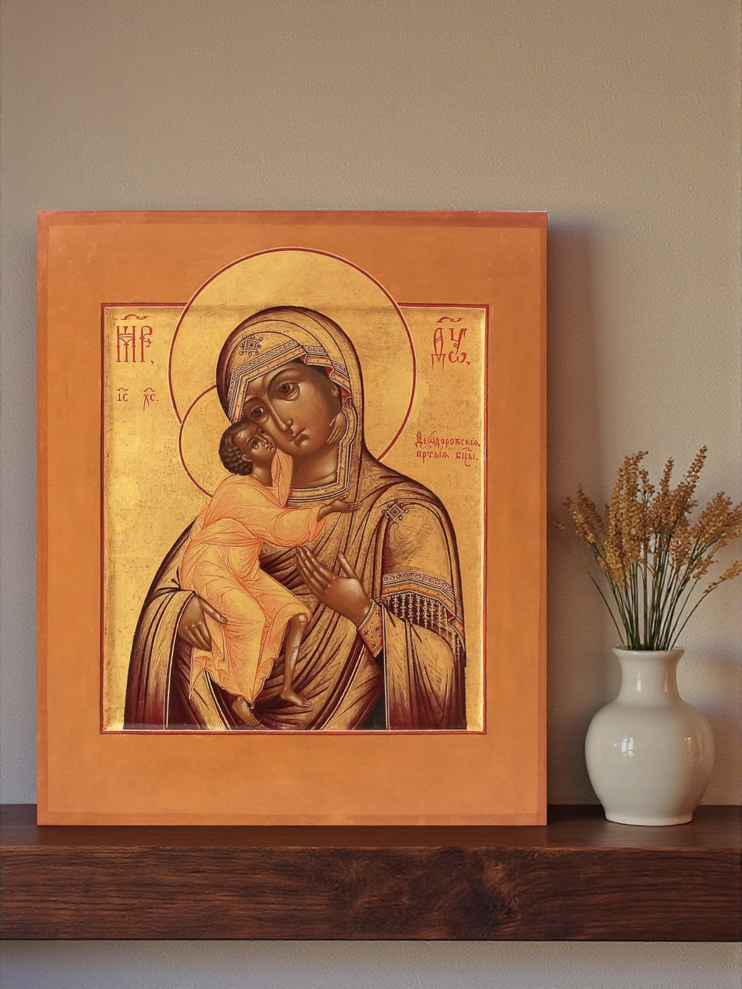 The Feodorov Icon depicts the Mother of God tenderly holding the Christ Child, who sits upon her left arm while blessing with His right hand.