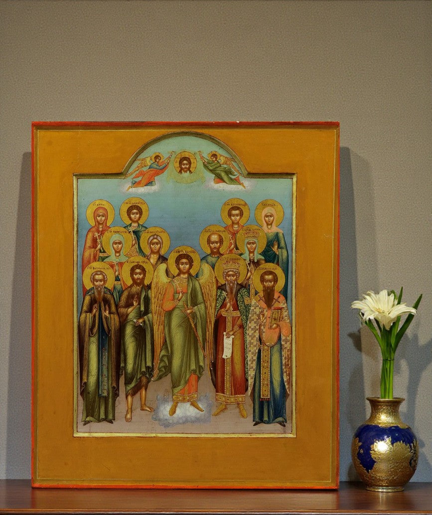 At the center of the composition stands the Guardian Angel, a heavenly protector appointed by God to guide and safeguard every Christian soul.