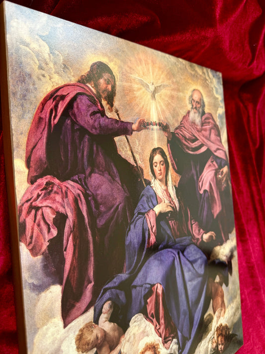 Christ and God the Father hold a wreath of roses over Mary's head&nbsp;— not a crown of gold and precious stones, but a garland of roses, the flower of love and the flower of the Rosary