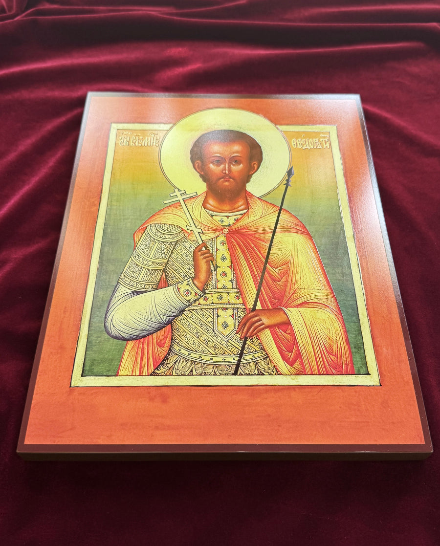A framed religious icon of Saint Theodore on a deep red velvet background. T