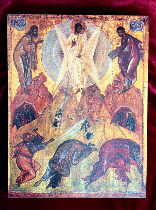 An antique Eastern Orthodox icon painting depicting the Transfiguration, featuring a central figure of Jesus Christ on a golden mountain with angels and figures in the surrounding rocks, set against a dark red velvet background.